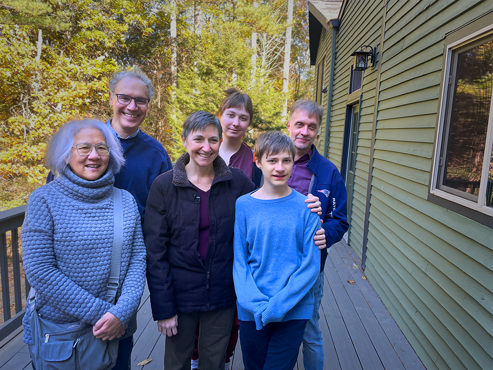 Rosalind “Candy” Lee, Victor Ambros, Melanie Barton-Zoltan; Tara, Daniel and Erik Zoltan stand outside together on the deck surrounded by trees in the background
